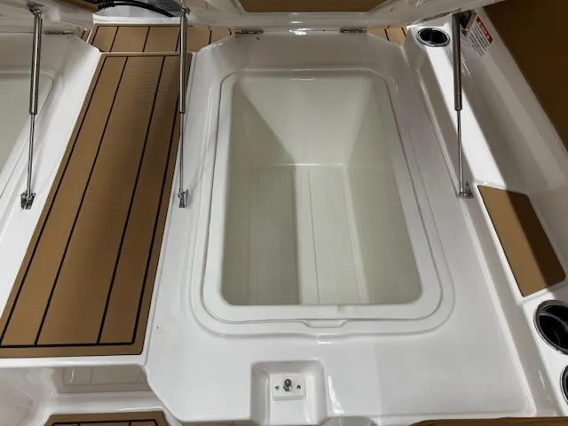 Slide: The Image of 2025 Chaparral 250 OSX boat storage compartment with teak-style flooring. - 19