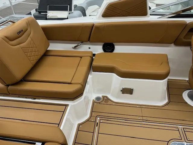 Slide: The Image of 2025 Chaparral 250 OSX boat interior with tan leather seating and teak flooring. - 20
