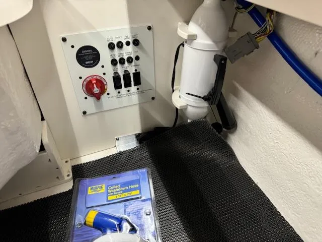 Slide: The Image of Control panel and equipment in 2025 Chaparral 250 OSX boat interior. - 22