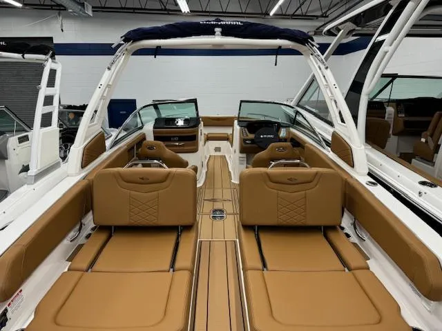 Slide: The Image of 2025 Chaparral 250 OSX boat interior with tan leather seating and modern dashboard. - 24