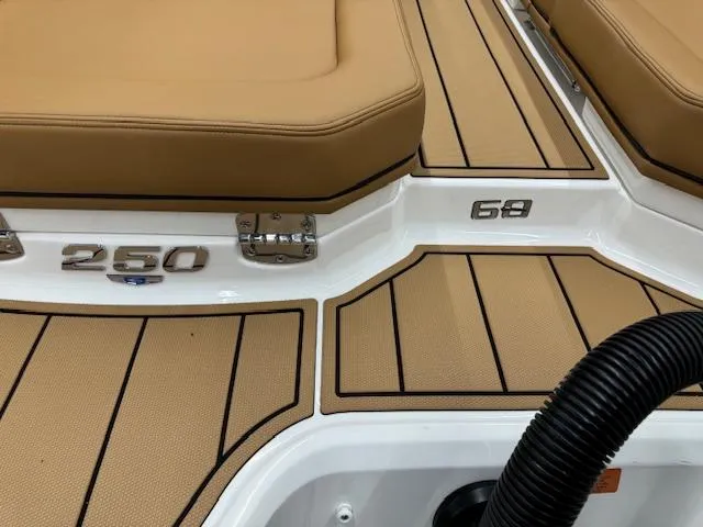 Slide: The Image of 2025 Chaparral 250 OSX boat deck with tan seating and sleek design. - 26