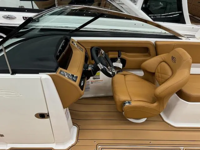 Slide: The Image of 2025 Chaparral 250 OSX boat interior with tan leather seating and modern dashboard. - 4