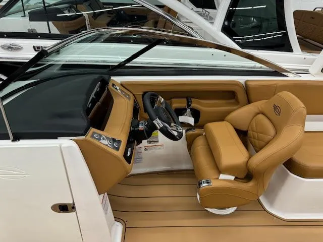 Slide: The Image of 2025 Chaparral 250 OSX boat interior with tan leather seating and modern dashboard. - 5