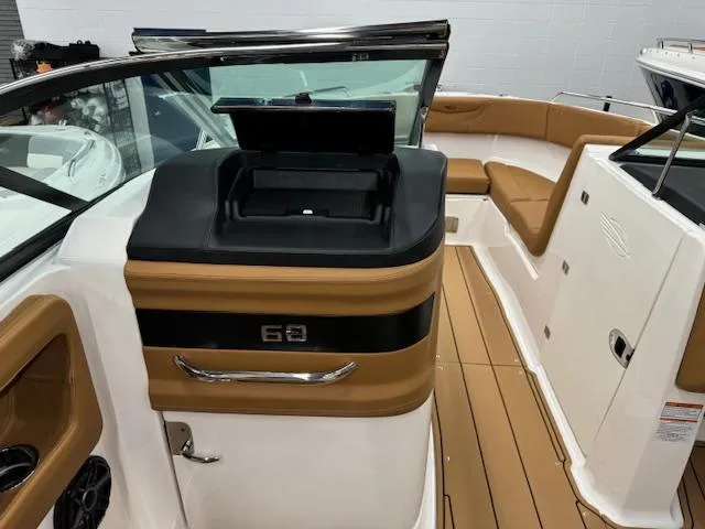 Slide: The Image of 2025 Chaparral 250 OSX boat interior with tan seating and sleek design. - 9