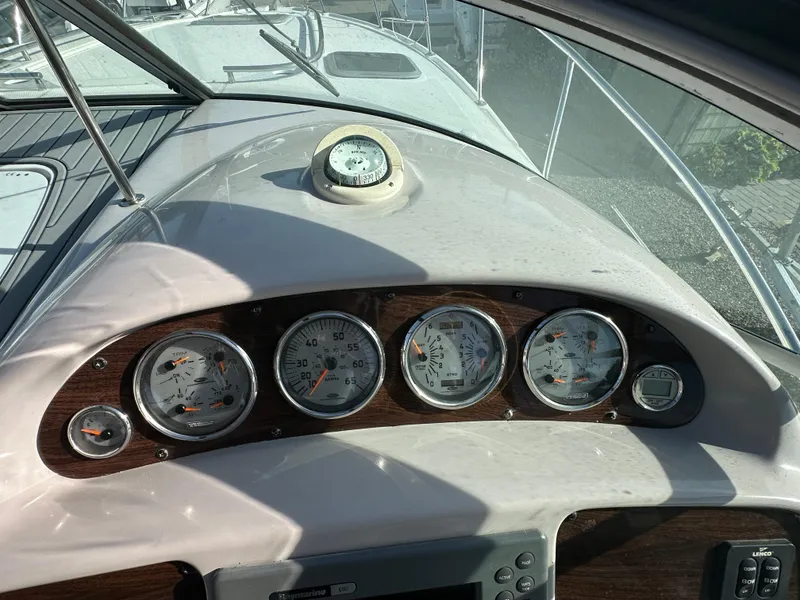 Slide: The Image of 2007 Chaparral 310 Signature boat dashboard with gauges and compass. - 13