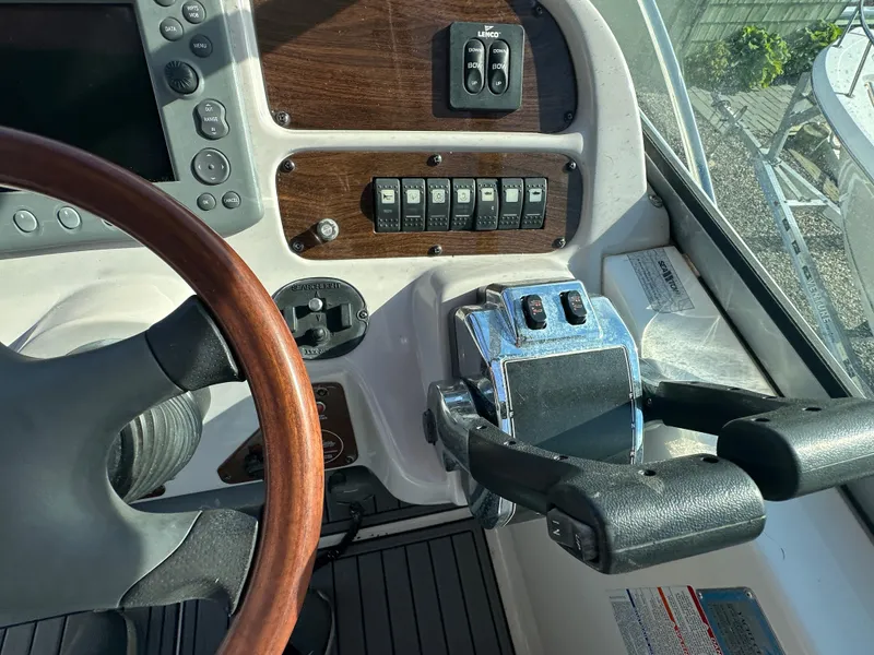 Slide: The Image of Close-up of 2007 Chaparral 310 Signature boat helm with controls and steering wheel. - 16