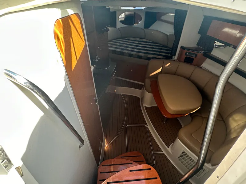 Slide: The Image of Interior of 2007 Chaparral 310 Signature boat with seating and sleeping area. - 19