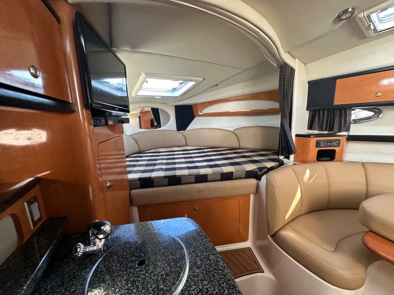 Slide: The Image of Interior of 2007 Chaparral 310 Signature boat with bed, seating, and kitchenette. - 23