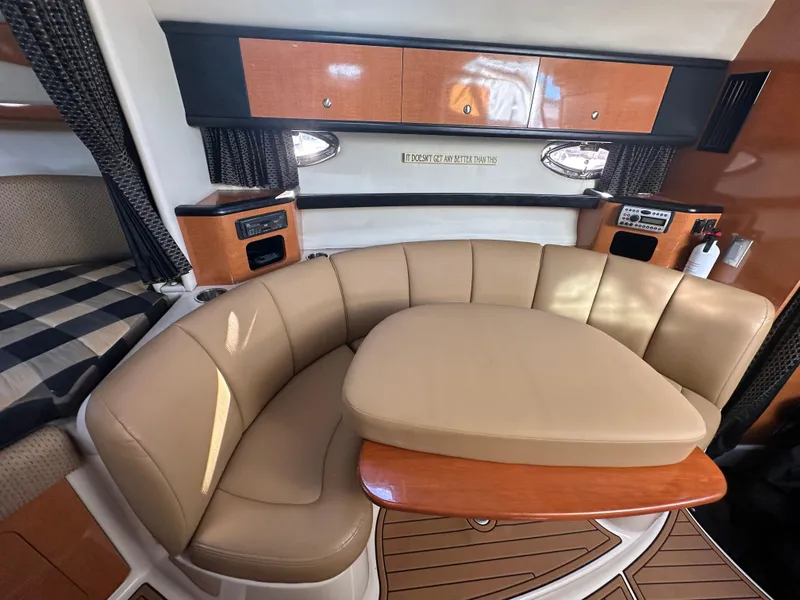 Slide: The Image of 2007 Chaparral 310 Signature yacht interior with leather seating and wooden table. - 24