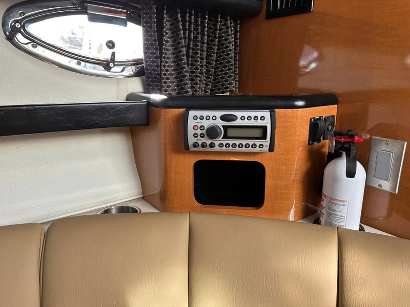 Slide: The Image of Interior of 2007 Chaparral 310 Signature boat with control panel and fire extinguisher. - 27