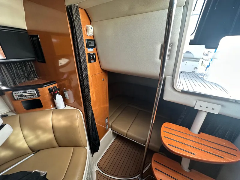 Slide: The Image of Interior cabin of a 2007 Chaparral 310 Signature boat with seating and control panel. - 31