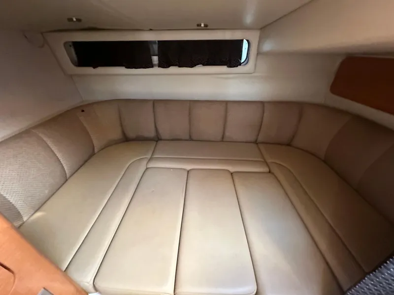 Slide: The Image of 2007 Chaparral 310 Signature cabin interior with beige upholstery and window. - 32