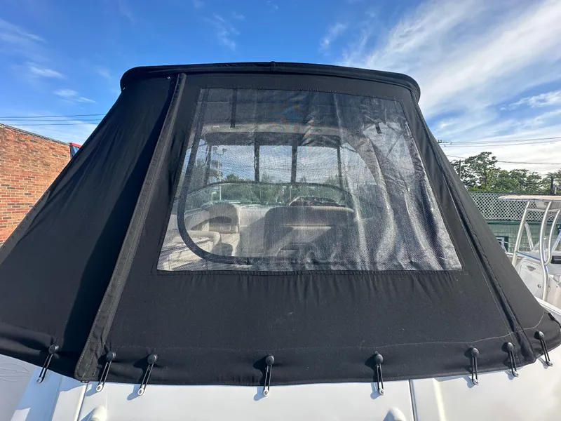 Slide: The Image of 2007 Chaparral 310 Signature boat with black canvas cover and clear window. - 4