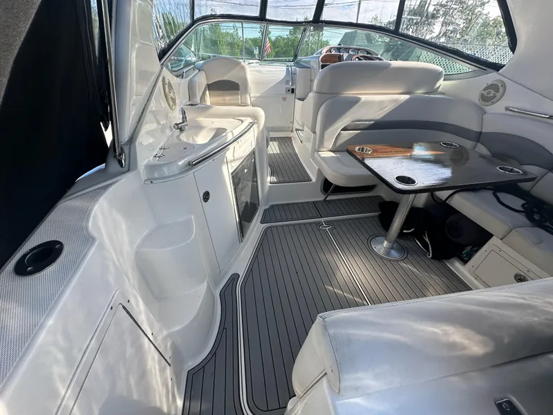 Slide: The Image of 2007 Chaparral 310 Signature boat interior with seating, table, and kitchenette. - 5
