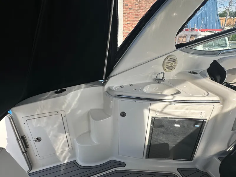 Slide: The Image of 2007 Chaparral 310 Signature boat interior with sink and storage compartments. - 8