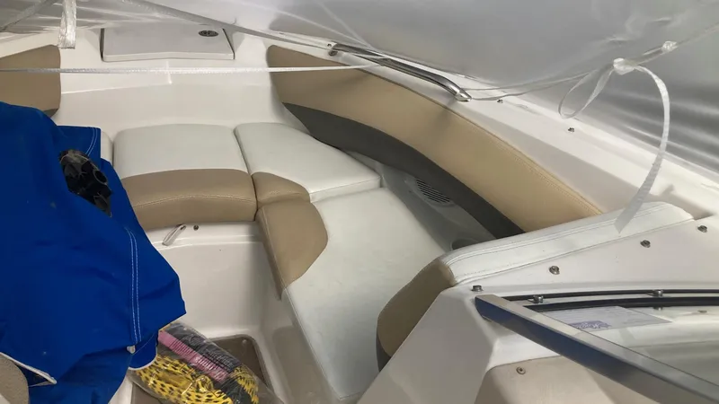Slide: The Image of Interior of a 2005 Larson 208LXi boat with beige and white seating. - 13