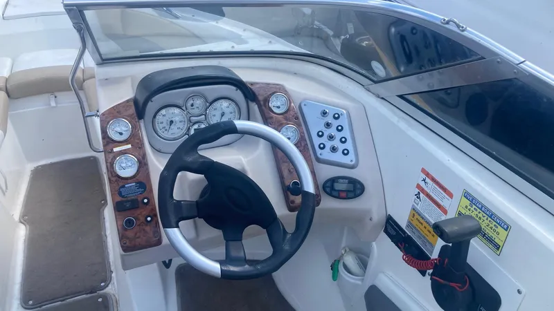 Slide: The Image of 2005 Larson 208LXi boat dashboard with steering wheel and instrument panel. - 4