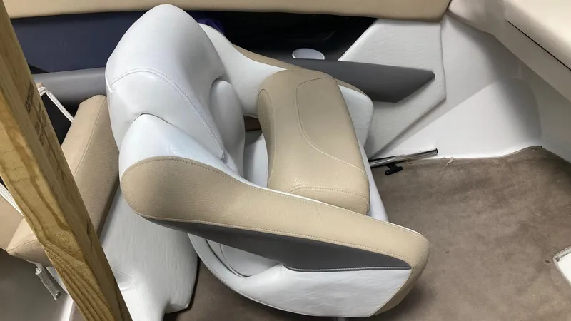 Slide: The Image of Boat interior seating of a 2005 Larson 208LXi, featuring beige and white upholstery. - 7