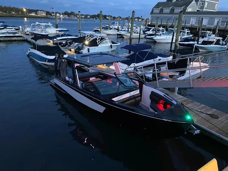 The Image of 2020 Aviara AV32 I/O boat docked at a marina during twilight. - 0