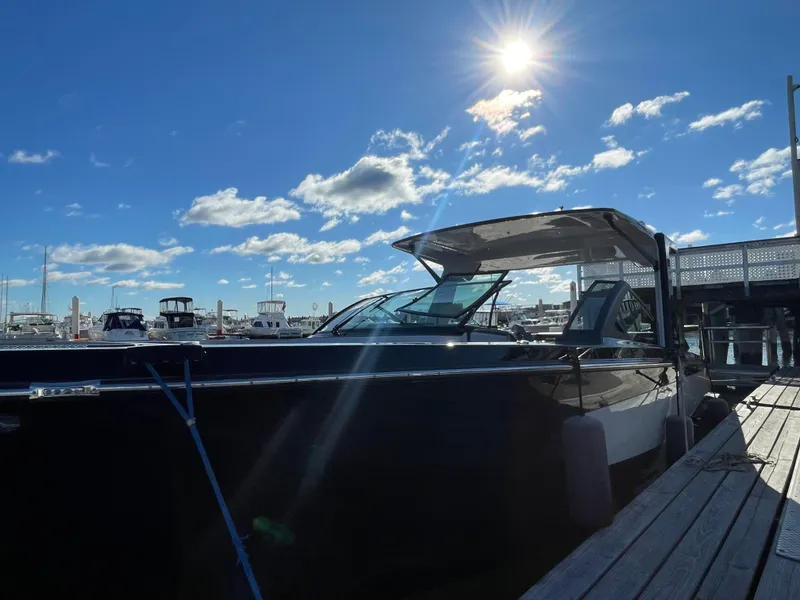 Slide: The Image of 2020 Aviara AV32 I/O boat docked under a sunny blue sky. - 11