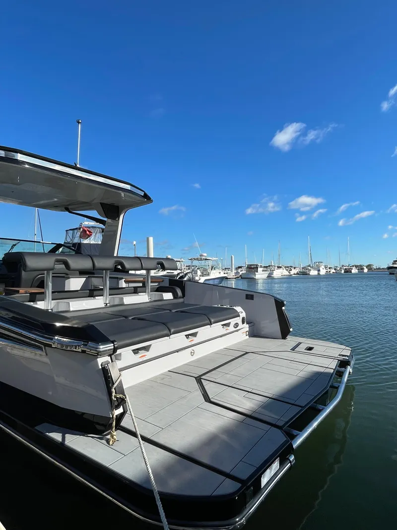 Slide: The Image of 2020 Aviara AV32 I/O boat docked in a marina under a clear blue sky. - 12