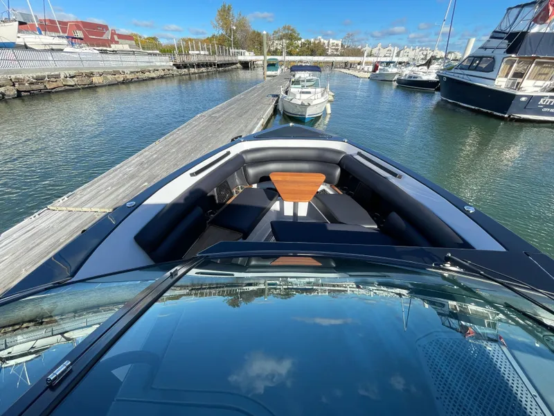 Slide: The Image of 2020 Aviara AV32 I/O boat docked in a marina, featuring sleek design and spacious seating. - 15