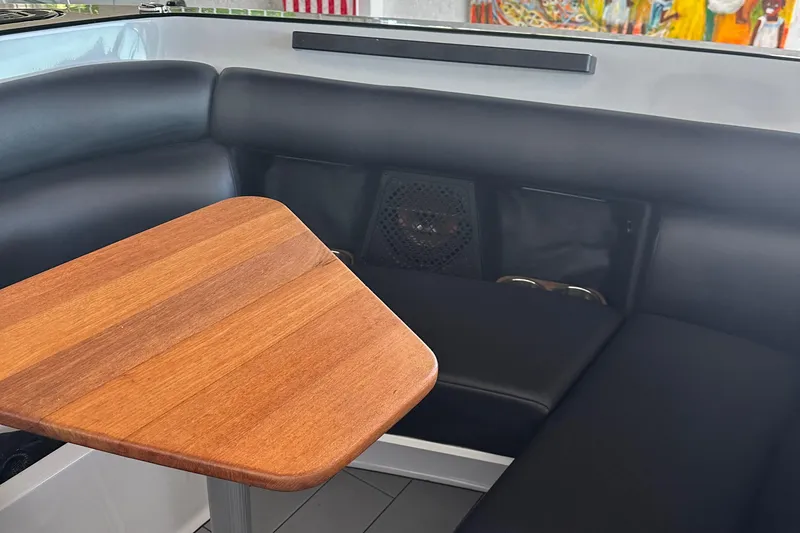 Slide: The Image of Luxurious seating area on 2020 Aviara AV32 I/O boat with wooden table. - 22