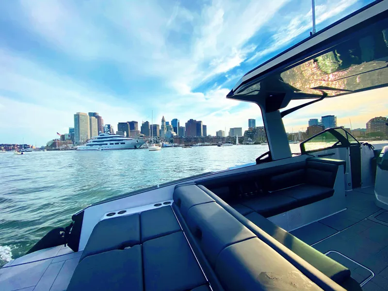 Slide: The Image of 2020 Aviara AV32 I/O boat with city skyline and waterfront view. - 24