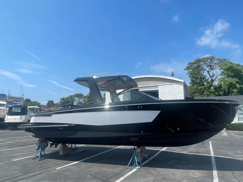 Slide: The Image of 2020 Aviara AV32 I/O boat on stands in a parking lot under a clear blue sky. - 4