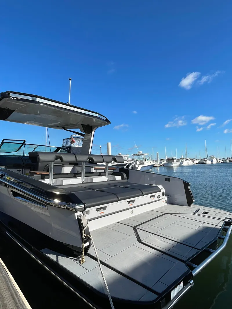 Slide: The Image of 2020 Aviara AV32 I/O boat docked at marina under clear blue sky. - 6