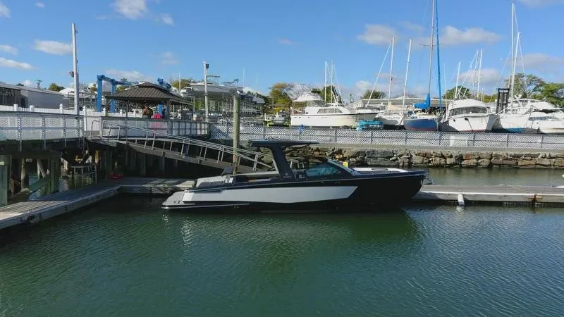 Slide: The Image of Aviara AV32 I/O 2020 boat docked at a marina with other vessels. - 8
