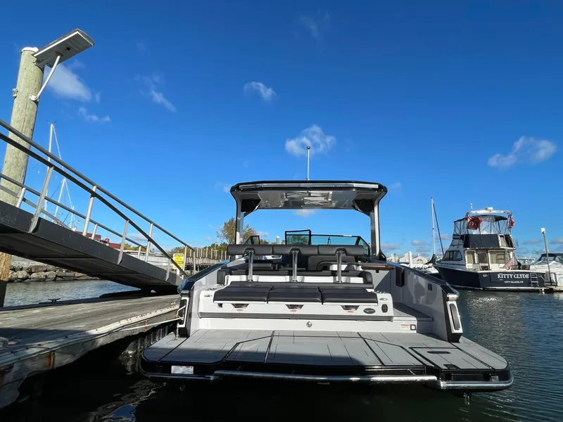 Slide: The Image of 2020 Aviara AV32 I/O boat docked at marina under clear blue sky. - 9