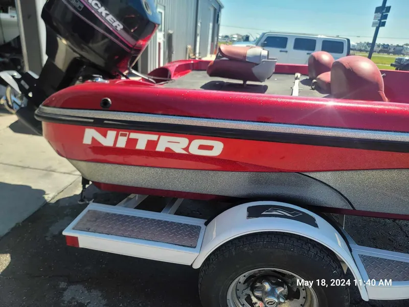 Slide: The Image of 2004 Nitro NX 750 SC red fishing boat on trailer. - 2