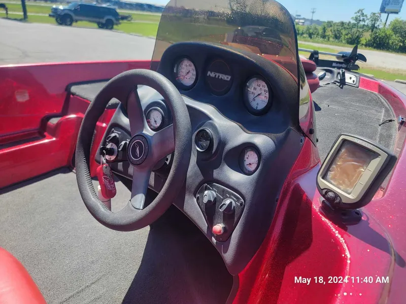 Slide: The Image of 2004 Nitro NX 750 SC boat dashboard with steering wheel and gauges. - 7
