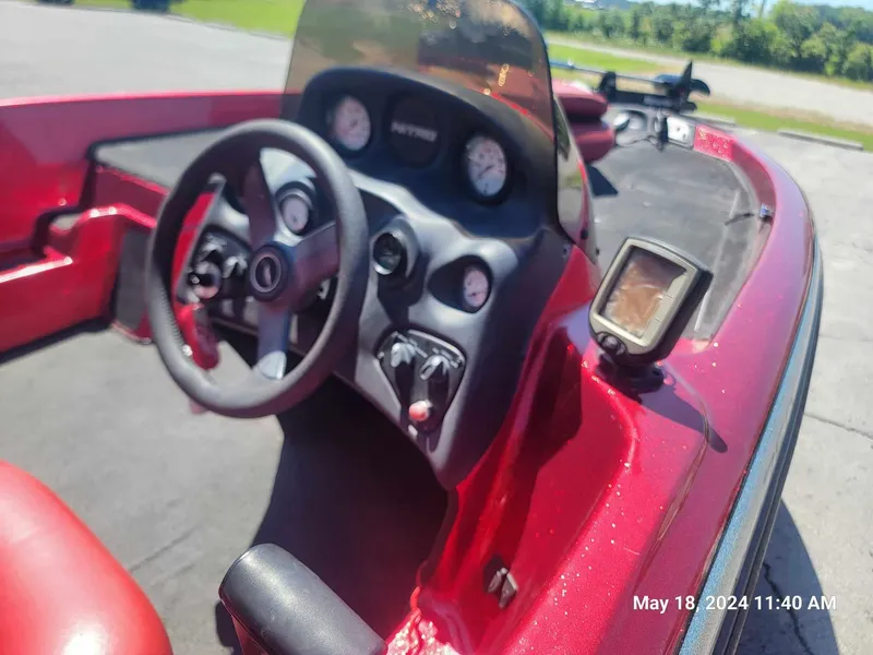 Slide: The Image of 2004 Nitro NX 750 SC boat dashboard with steering wheel and gauges. - 8