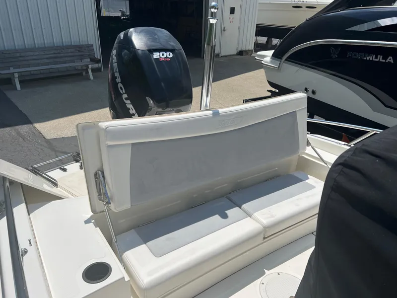 Slide: The Image of 2015 Boston Whaler 210 Dauntless boat with Mercury 200 engine, rear seating view. - 2