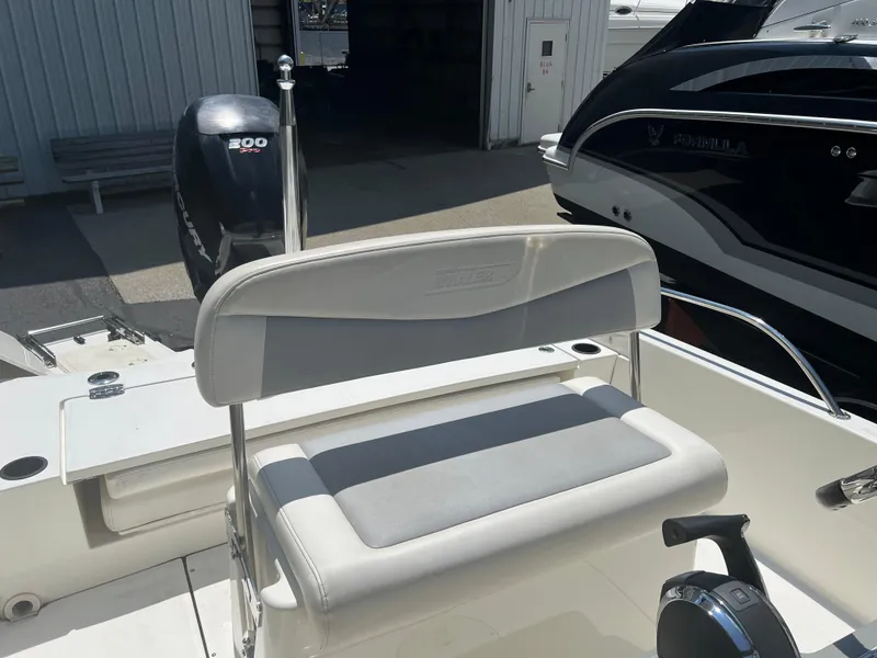 Slide: The Image of 2015 Boston Whaler 210 Dauntless boat with seating and outboard motor. - 5