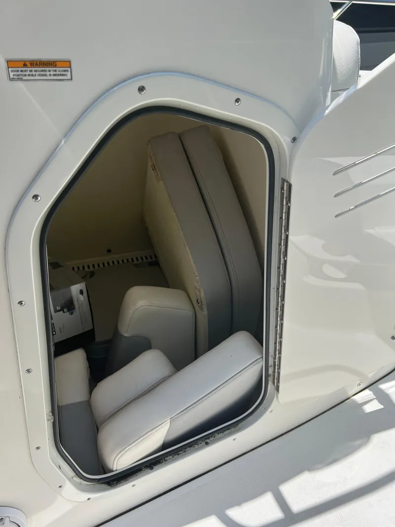 Slide: The Image of Storage compartment with cushioned seats on a 2015 Boston Whaler 210 Dauntless boat. - 6