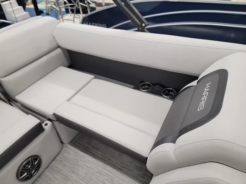 Slide: The Image of 2024 Harris Cruiser 230 boat interior with gray seating and cup holders. - 16