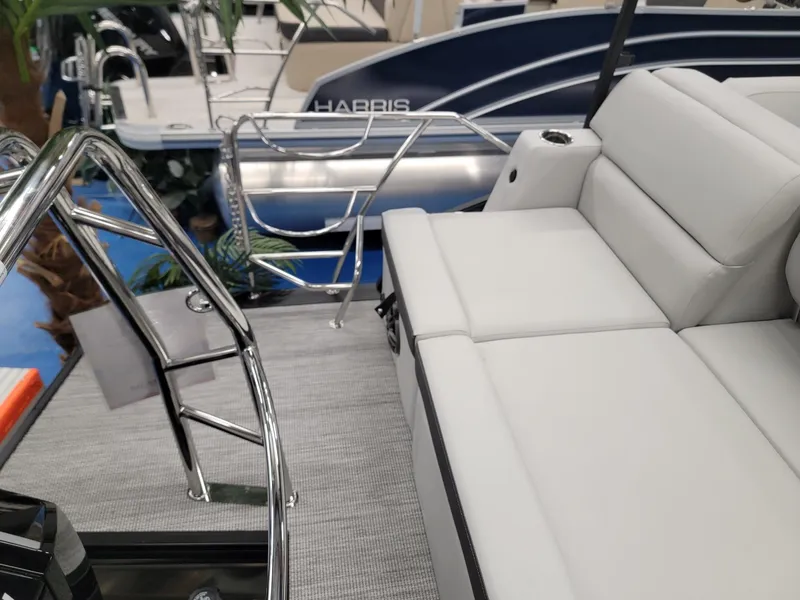 Slide: The Image of 2024 Harris Cruiser 230 boat interior with plush seating and stainless steel railings. - 20
