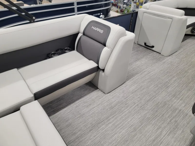 Slide: The Image of 2024 Harris Cruiser 230 boat interior with plush seating and cup holders. - 22