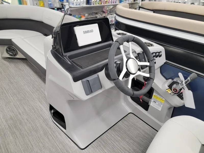 Slide: The Image of 2024 Harris Cruiser 230 boat interior with steering wheel and control panel. - 24