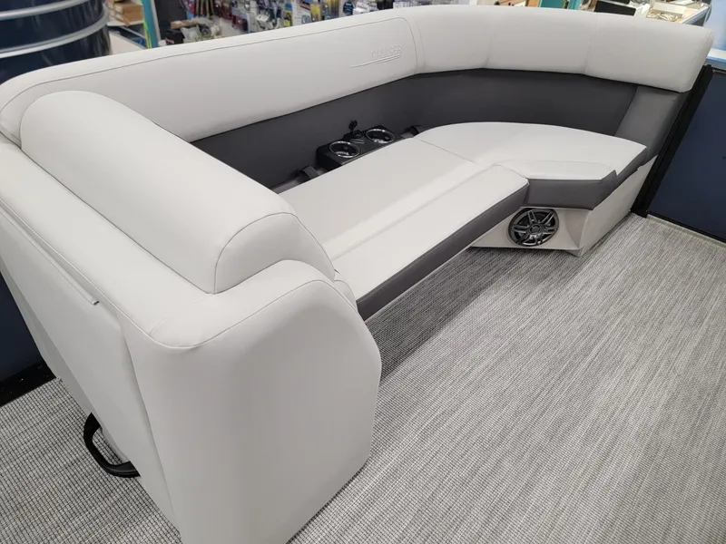 Slide: The Image of 2024 Harris Cruiser 230 boat interior with plush seating and cup holders. - 26