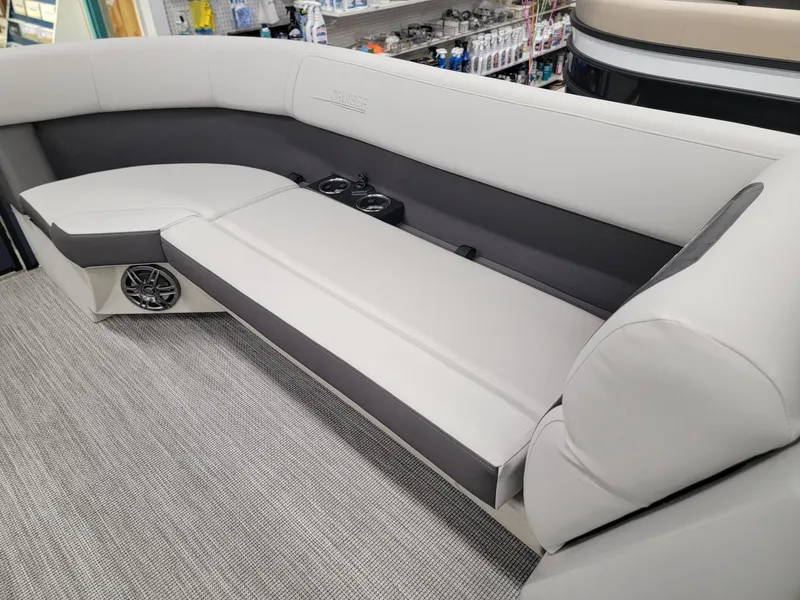 Slide: The Image of 2024 Harris Cruiser 230 boat interior seating with cup holders and speakers. - 27