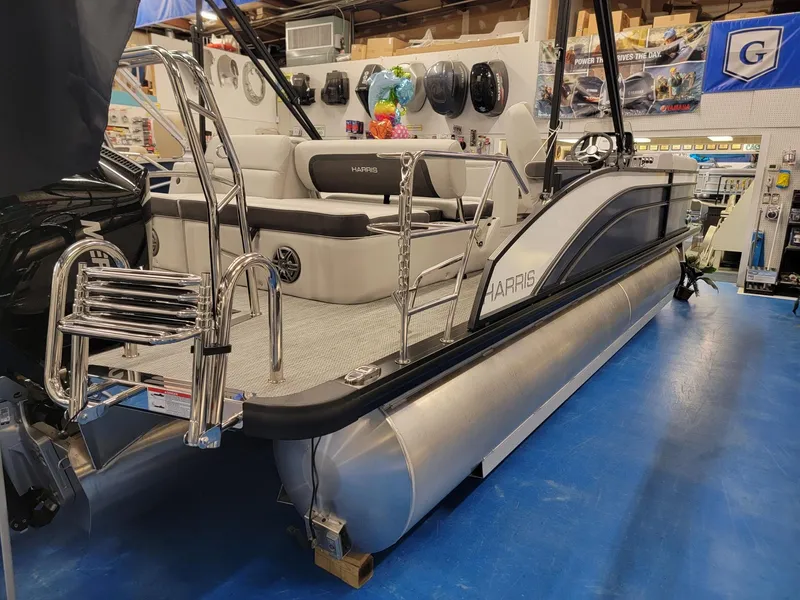 Slide: The Image of 2024 Harris Cruiser 230 pontoon boat displayed in a showroom. - 3