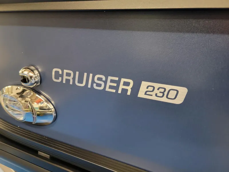 Slide: The Image of 2024 Harris Cruiser 230 boat nameplate in close-up view. - 30