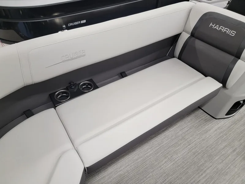 Slide: The Image of 2024 Harris Cruiser 230 boat interior with cushioned seating and cup holders. - 6