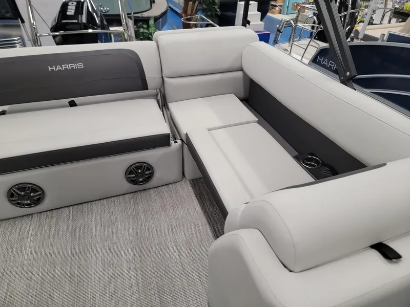 Slide: The Image of 2024 Harris Cruiser 230 boat interior with plush seating and built-in speakers. - 8