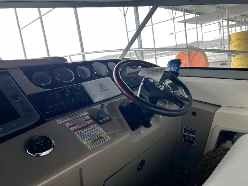 Slide: The Image of Helm of a 2008 Sea Ray 350 Sundancer yacht with steering wheel and control panel. - 11