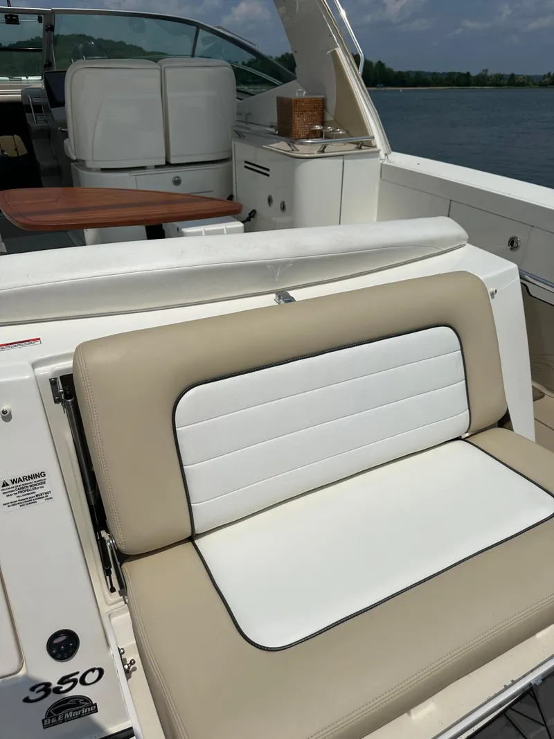 Slide: The Image of 2008 Sea Ray 350 Sundancer boat interior with beige and white seating. - 15